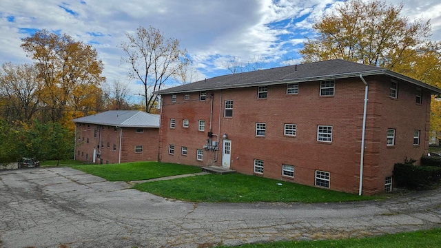 view of home's exterior featuring a yard and brick siding
