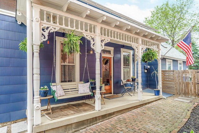exterior space with covered porch and fence
