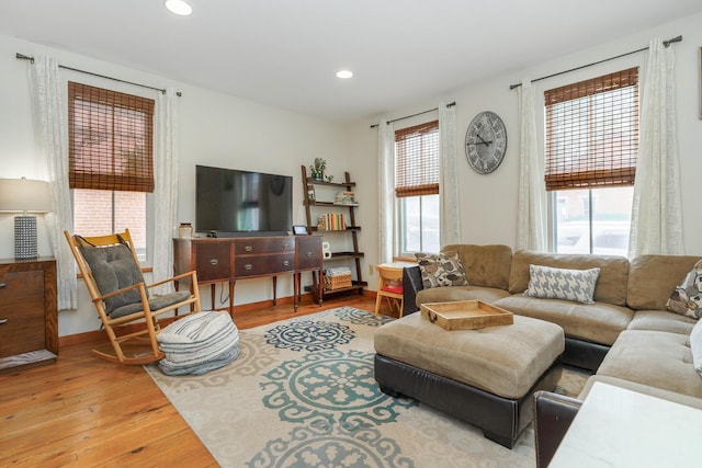 living area featuring recessed lighting and hardwood / wood-style flooring