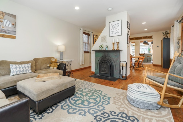 living area with wood finished floors, recessed lighting, and baseboards
