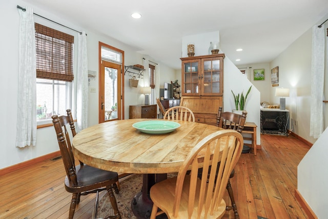 dining room with baseboards, recessed lighting, and light wood-style flooring