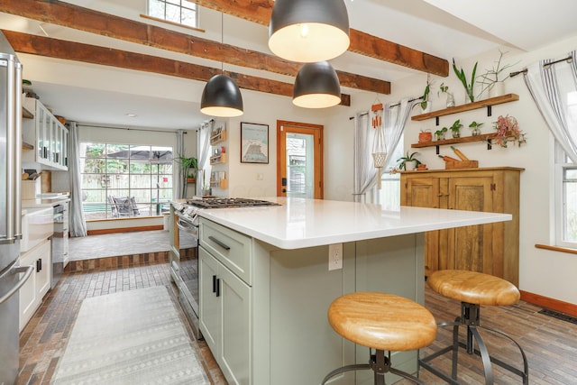 kitchen featuring light countertops, plenty of natural light, stainless steel range with gas stovetop, and open shelves