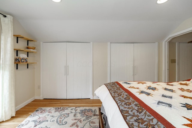 bedroom with recessed lighting, baseboards, vaulted ceiling, and light wood-style floors
