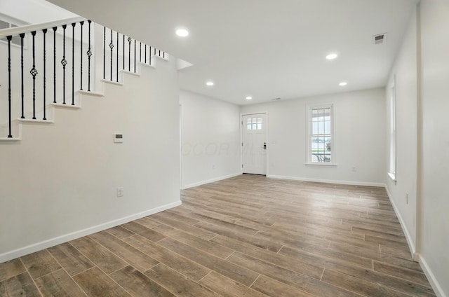 entrance foyer featuring baseboards, recessed lighting, and wood finished floors