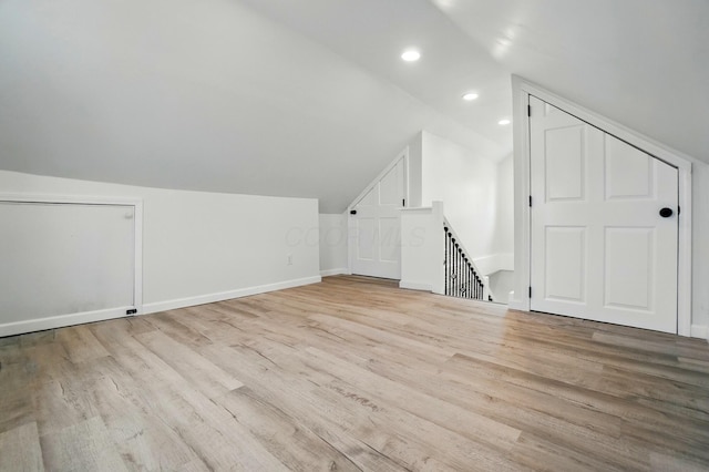 bonus room with recessed lighting, baseboards, wood finished floors, and lofted ceiling