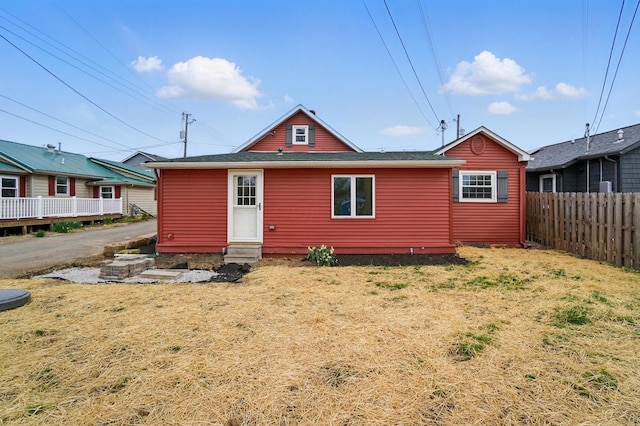 back of house with a yard, entry steps, and fence