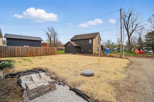 view of yard featuring fence and an outdoor structure