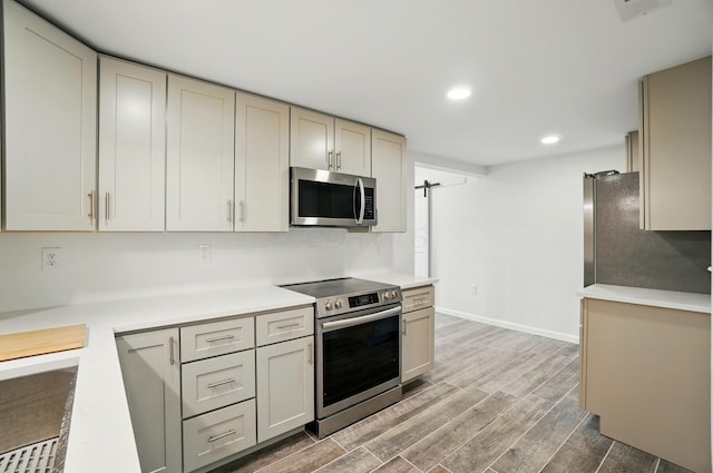 kitchen featuring visible vents, light countertops, appliances with stainless steel finishes, light wood-style floors, and recessed lighting