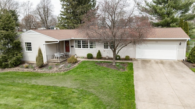 ranch-style house with roof with shingles, an attached garage, driveway, and a front lawn