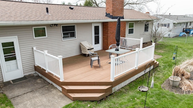 wooden deck with a yard and fence