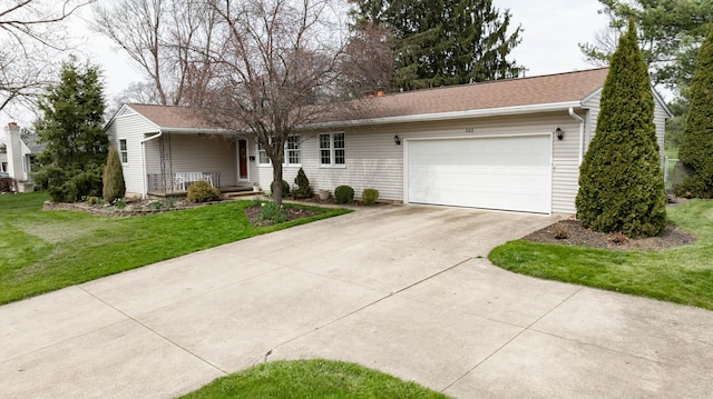 ranch-style home featuring a porch, driveway, a garage, and a front yard
