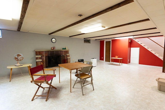 dining room featuring stairway and a brick fireplace