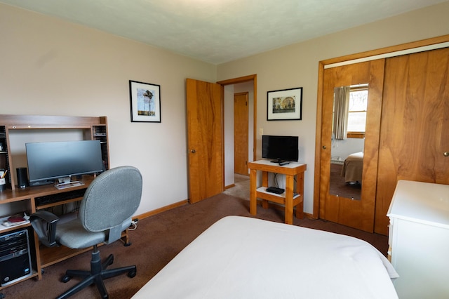 bedroom with a closet, baseboards, and carpet