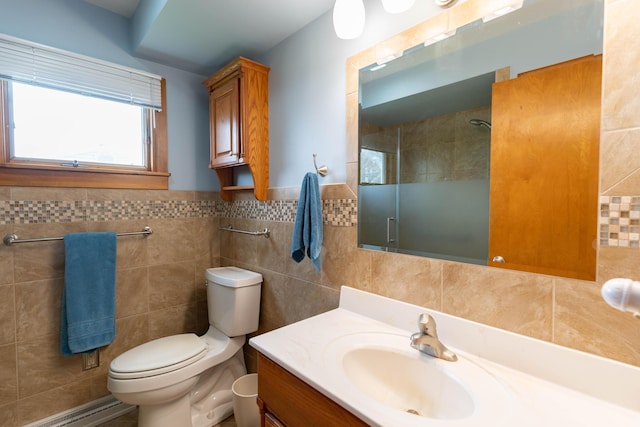 bathroom with toilet, tile walls, a tile shower, and vanity