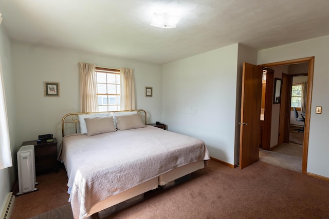 carpeted bedroom featuring a baseboard heating unit, multiple windows, and baseboards