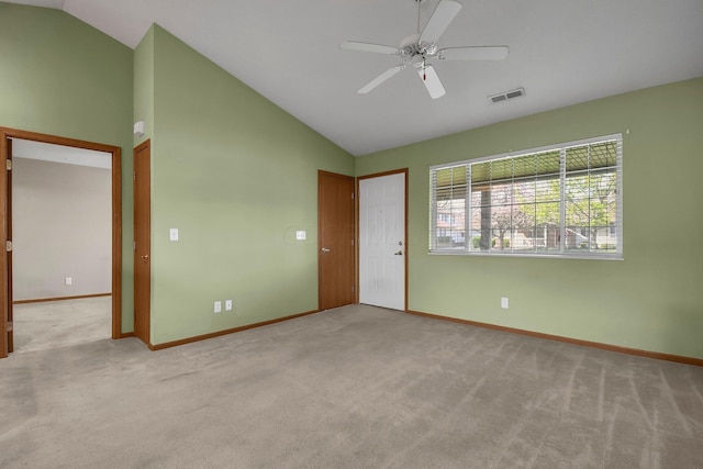 carpeted spare room featuring baseboards, visible vents, high vaulted ceiling, and ceiling fan