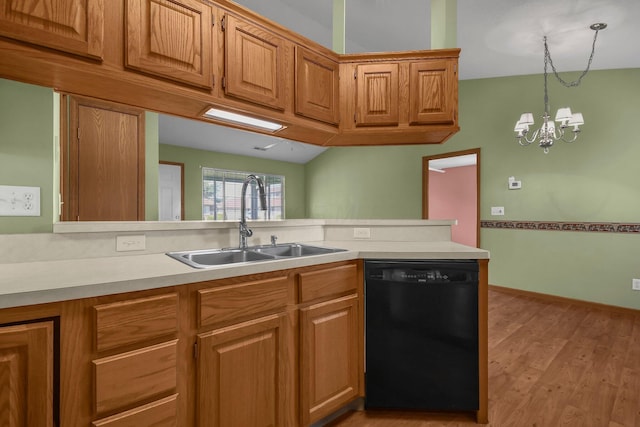kitchen featuring an inviting chandelier, dishwasher, light countertops, and a sink