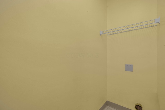 laundry area with baseboards, tile patterned flooring, and laundry area
