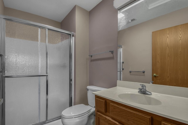 full bathroom with a stall shower, vanity, visible vents, and toilet