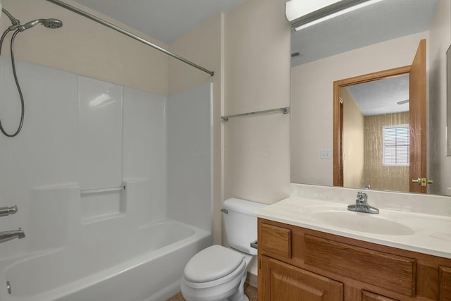 bathroom featuring toilet, vanity, and shower / bathing tub combination