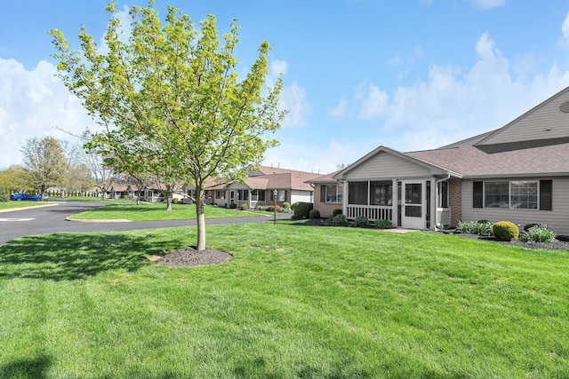 view of yard featuring a sunroom