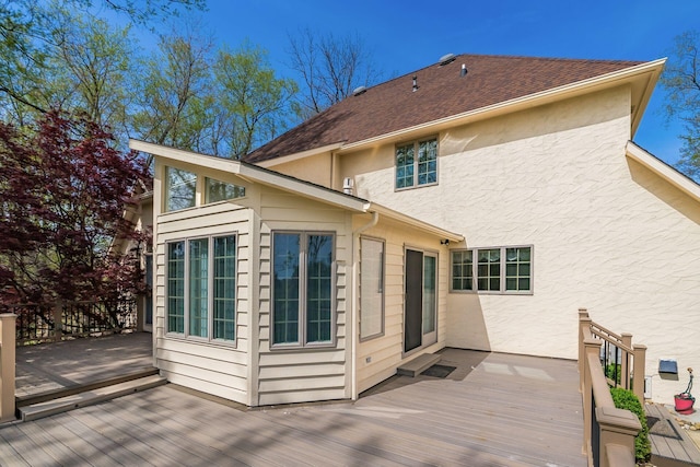 1354 Hemlock Ct NE, Lancaster, OH 43130 - back of house featuring stucco siding, a wooden deck, and a shingled roof