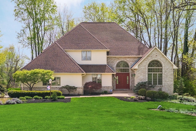 1354 Hemlock Ct NE, Lancaster, OH 43130 - view of front of home featuring brick siding, a shingled roof, and a front yard