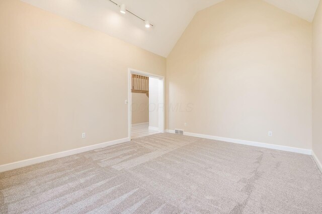 1354 Hemlock Ct NE, Lancaster, OH 43130 - spare room featuring high vaulted ceiling, track lighting, light carpet, baseboards, and visible vents