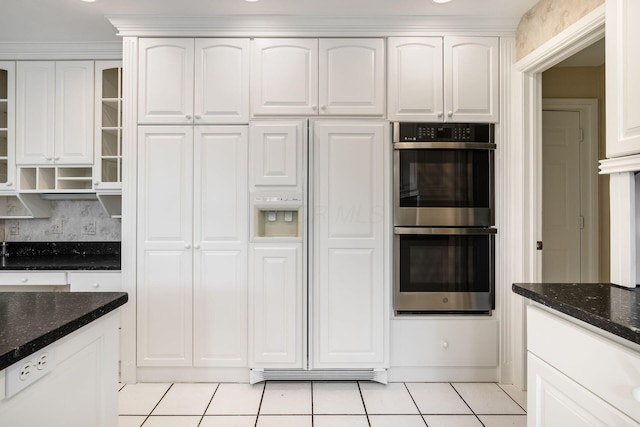 1354 Hemlock Ct NE, Lancaster, OH 43130 - kitchen featuring dark stone counters, light tile patterned flooring, glass insert cabinets, double oven, and white cabinetry