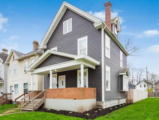85 Dana Ave, Columbus, OH 43222 - view of front of property featuring a chimney, a front yard, covered porch, and fence