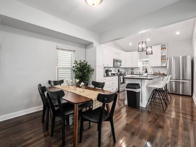 85 Dana Ave, Columbus, OH 43222 - dining space featuring recessed lighting, dark wood finished floors, vaulted ceiling, and baseboards