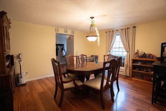 dining room with baseboards, a textured ceiling, and dark wood-type flooring