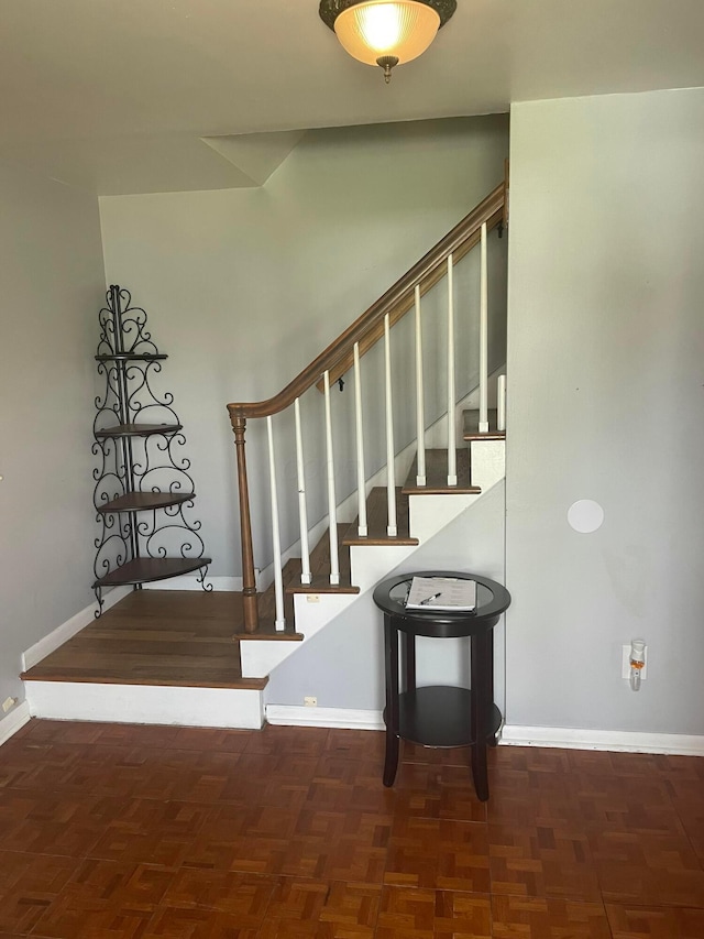 staircase featuring baseboards