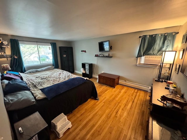 751 Vicksburg Dr, Mansfield, OH 44904 - bedroom with baseboard heating, light wood-style flooring, a baseboard heating unit, and cooling unit