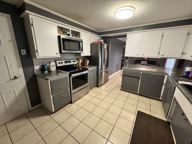 751 Vicksburg Dr, Mansfield, OH 44904 - kitchen with appliances with stainless steel finishes, ornamental molding, light tile patterned flooring, white cabinetry, and baseboards