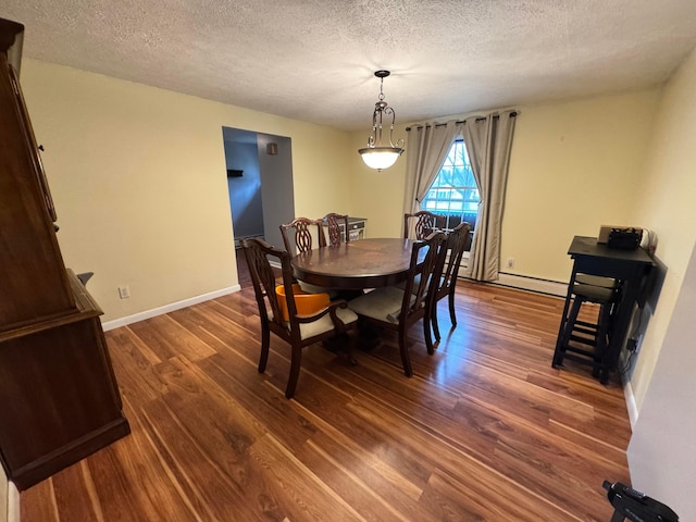 751 Vicksburg Dr, Mansfield, OH 44904 - dining area featuring dark wood finished floors, a textured ceiling, and baseboards