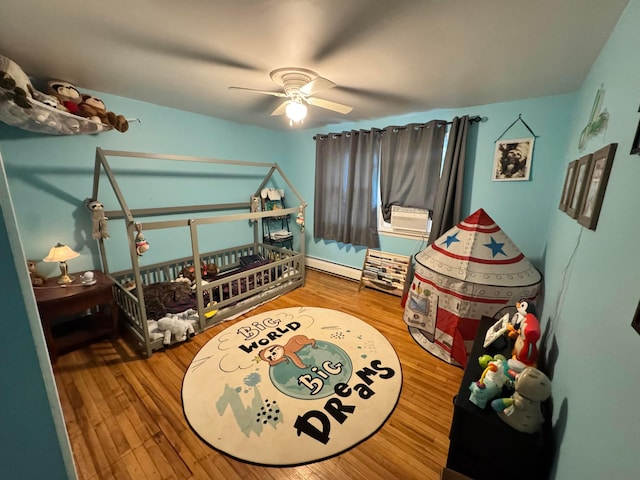 751 Vicksburg Dr, Mansfield, OH 44904 - bedroom with a baseboard heating unit, wood finished floors, a ceiling fan, and cooling unit