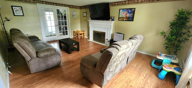 751 Vicksburg Dr, Mansfield, OH 44904 - living area with wood finished floors, a fireplace with flush hearth, and baseboards