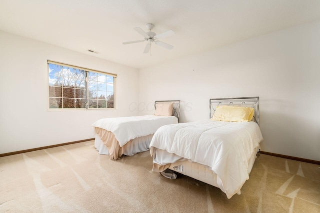 carpeted bedroom featuring baseboards, ceiling fan, and visible vents