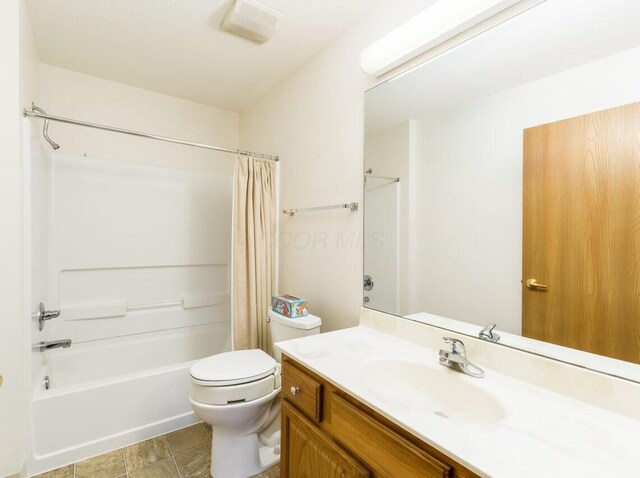 bathroom with visible vents, shower / tub combo, toilet, and vanity