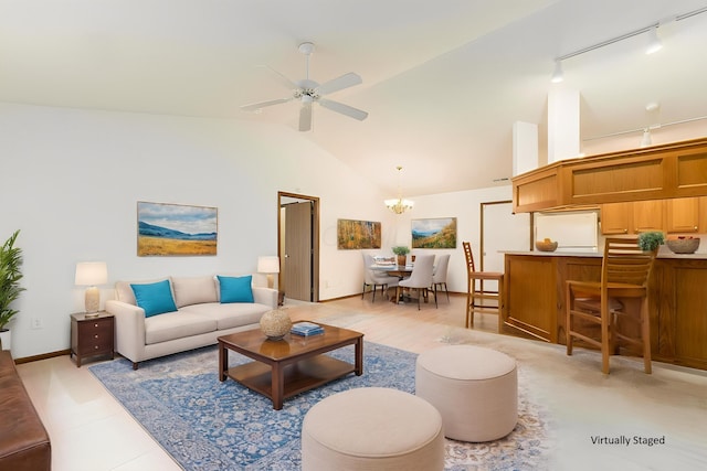 living room with track lighting, baseboards, ceiling fan with notable chandelier, and lofted ceiling