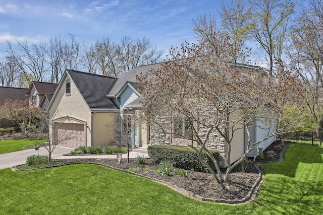 665 Cherrington Rd, Westerville, OH 43081 - view of front of home with concrete driveway, fence, an attached garage, a front yard, and stucco siding