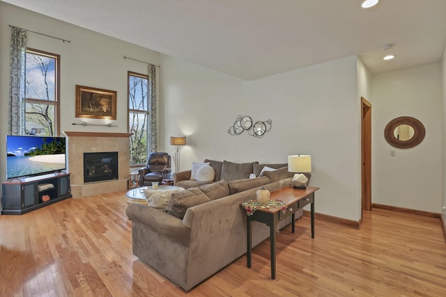 665 Cherrington Rd, Westerville, OH 43081 - living room featuring light wood-type flooring, a fireplace, and a healthy amount of sunlight