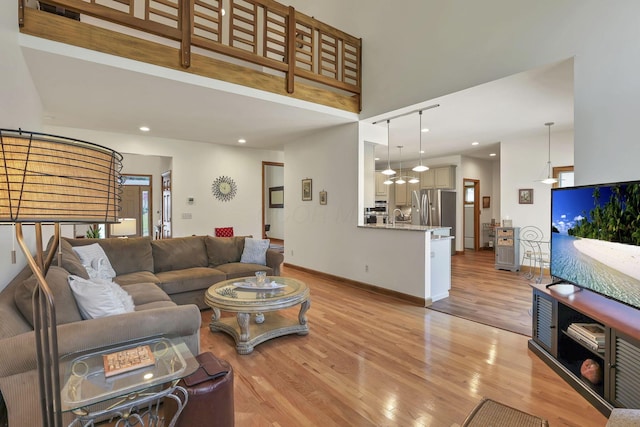 665 Cherrington Rd, Westerville, OH 43081 - living room with light wood-type flooring, baseboards, a high ceiling, and recessed lighting