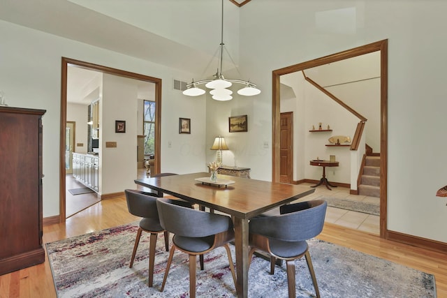 665 Cherrington Rd, Westerville, OH 43081 - dining area featuring a chandelier, stairs, visible vents, and light wood-type flooring