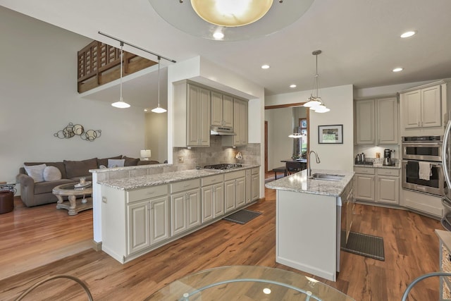665 Cherrington Rd, Westerville, OH 43081 - kitchen with dark wood finished floors, stainless steel appliances, under cabinet range hood, a sink, and tasteful backsplash
