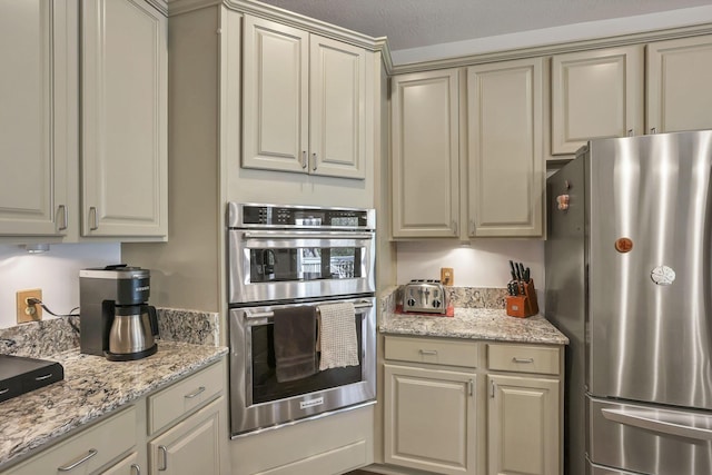 665 Cherrington Rd, Westerville, OH 43081 - kitchen with appliances with stainless steel finishes, cream cabinetry, and light stone counters