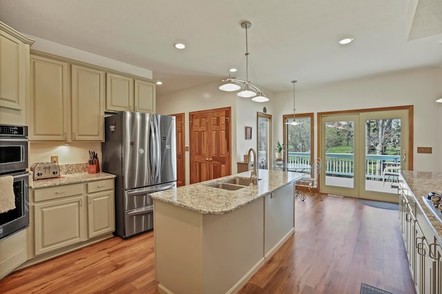 665 Cherrington Rd, Westerville, OH 43081 - kitchen with recessed lighting, cream cabinetry, stainless steel appliances, a sink, and light wood-type flooring