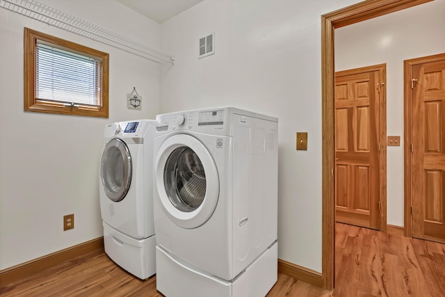 665 Cherrington Rd, Westerville, OH 43081 - clothes washing area featuring washing machine and clothes dryer, light wood-style flooring, visible vents, and laundry area