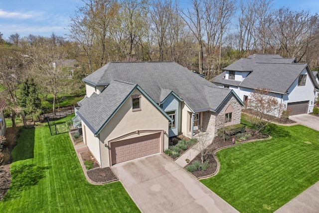 665 Cherrington Rd, Westerville, OH 43081 - view of front of home with a garage, concrete driveway, roof with shingles, and stucco siding